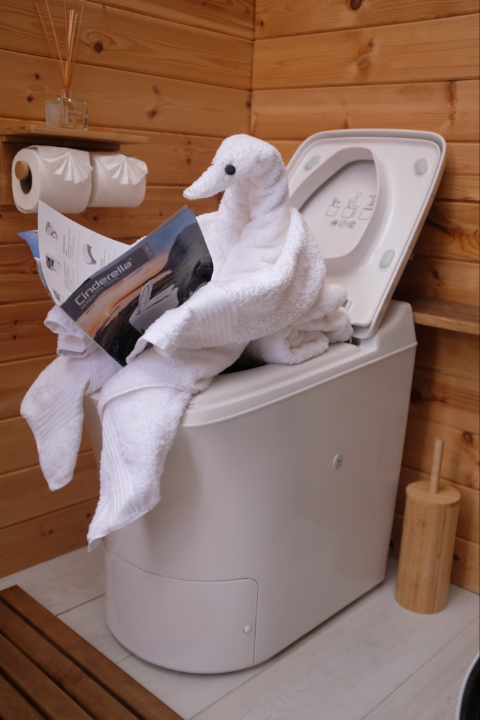 duck shaped towel sitting on Cinderella Toilet